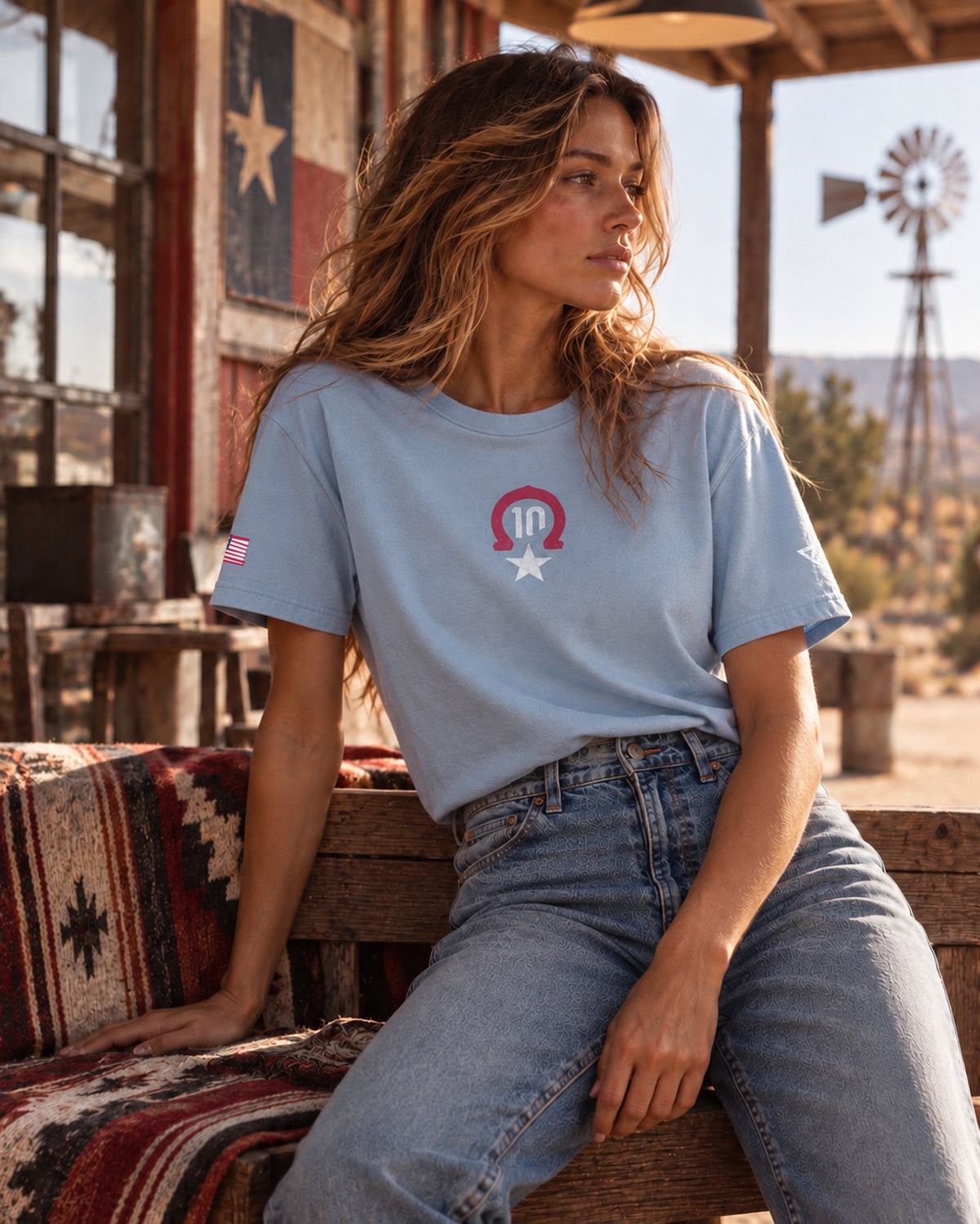 Woman wearing the blue Pierre Gasly Austin Tee, front view with the number 10 horseshoe logo