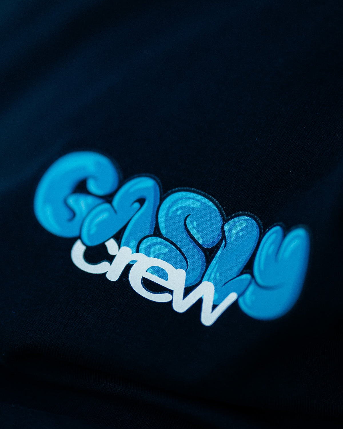 Close-up of the GASLY crew logo on the black Gasly Crew tee