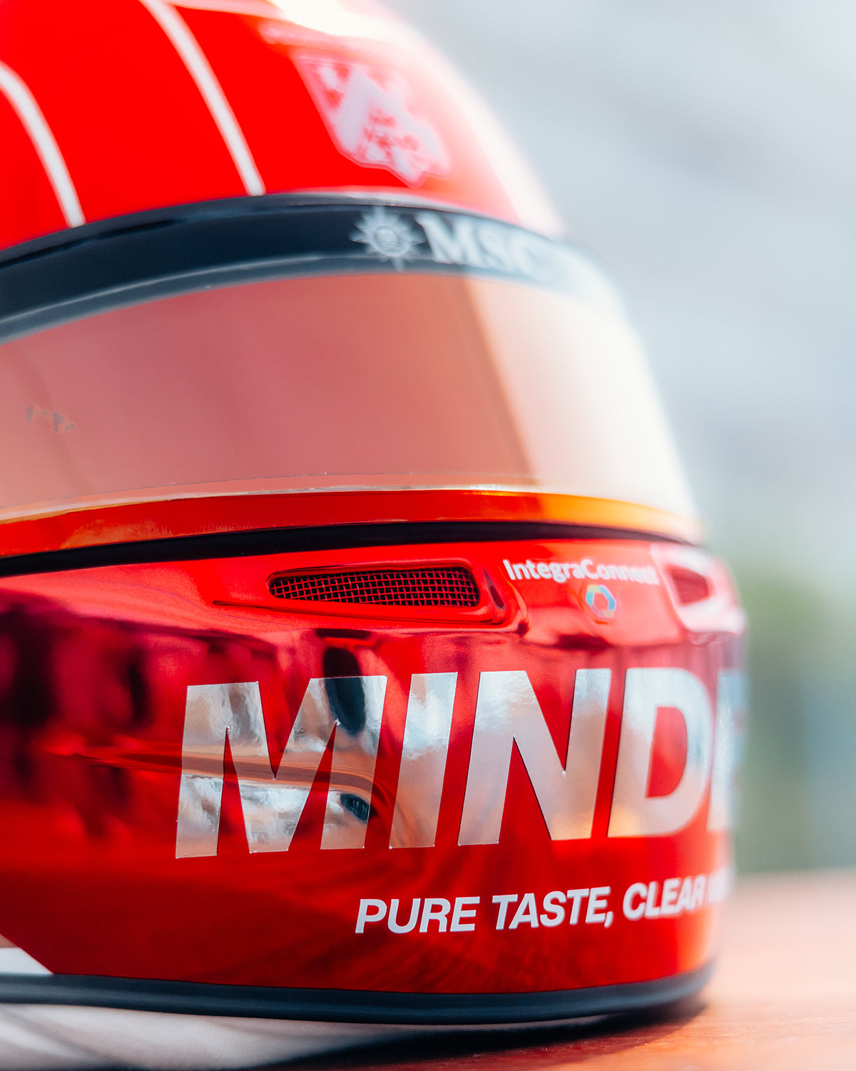 Close-up of the red chrome finish and MINDED livery on Pierre Gasly's 2026 Monaco Grand Prix race helmet